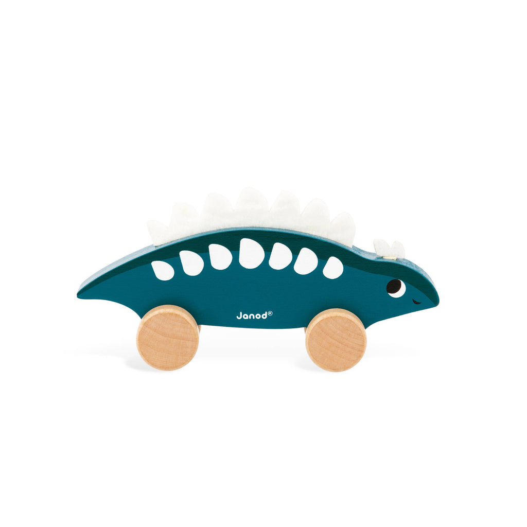Toy dinosaur with wooden wheels on a white background