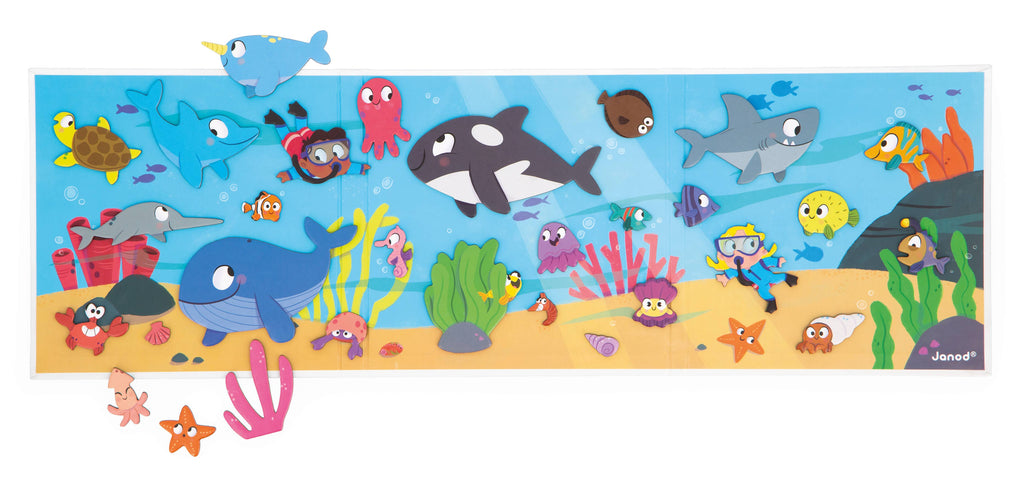Colorful underwater scene with various sea creatures and a scuba diver, featuring the brand 'Janod'.