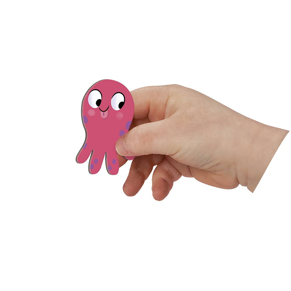Hand holding a pink cartoon octopus on a white background