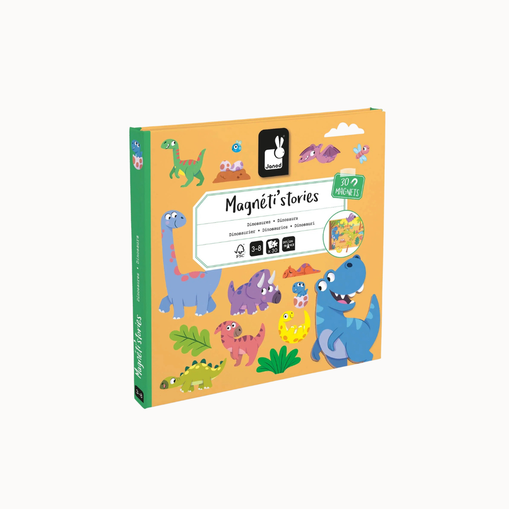 A boxed children's activity product titled "Magnéti stories" shown on a plain light background. The package is predominantly warm orange/peach with a green spine and side, and the front features colorful cartoon dinosaurs and small illustrated elements.