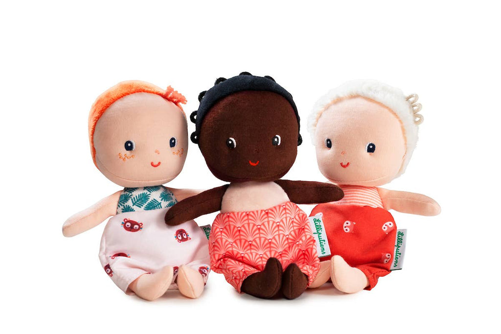 Three plush dolls with different skin tones and outfits on a white background