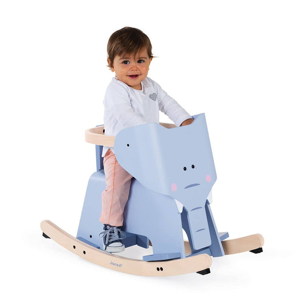 Child sitting on a blue rocking horse toy against a white background