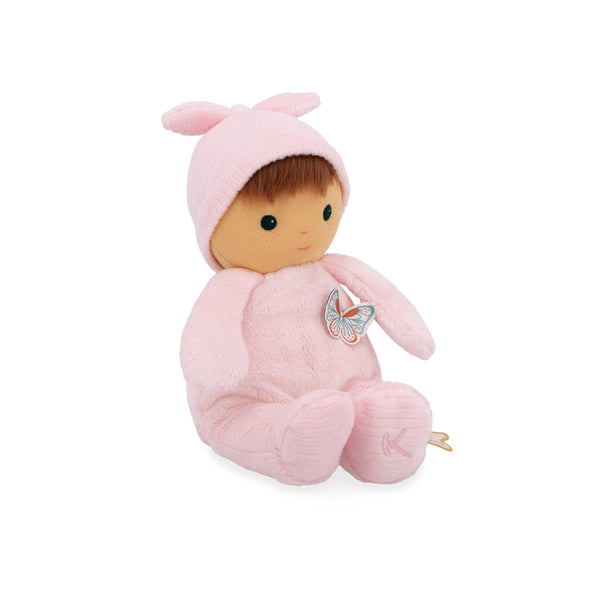 Stuffed toy baby doll in a pink outfit with a butterfly patch on a white background