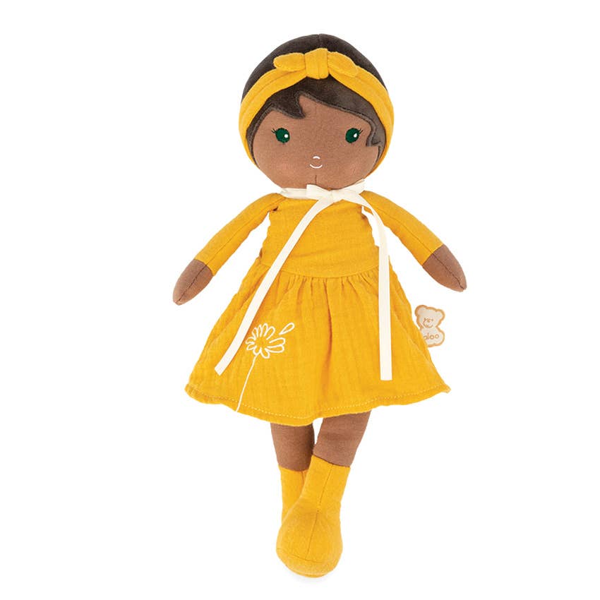 Doll in a yellow outfit with a white background
