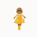 A doll with dark brown skin and black hair wearing a bright yellow dress, matching yellow headband, and yellow socks, shown against a plain white background.