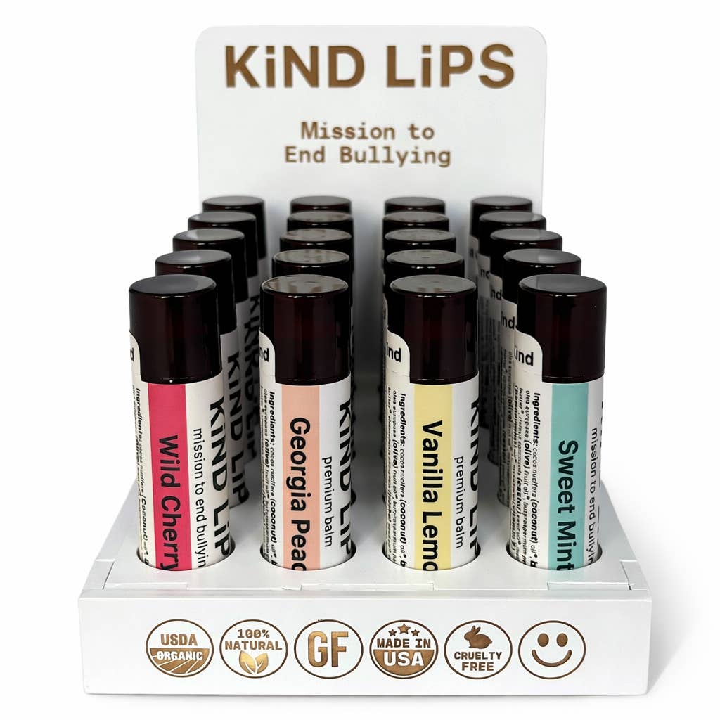 Display of Kind Lips lip balm tubes with a mission statement on a white background