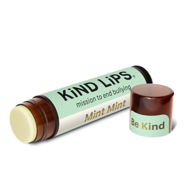 Lip balm with 'Kind Lips' packaging on a white background