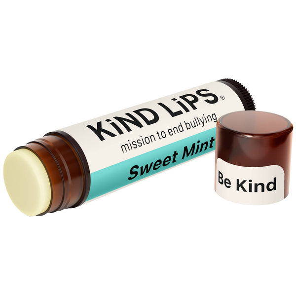 Lip balm with 'Kind Lips' packaging on a white background