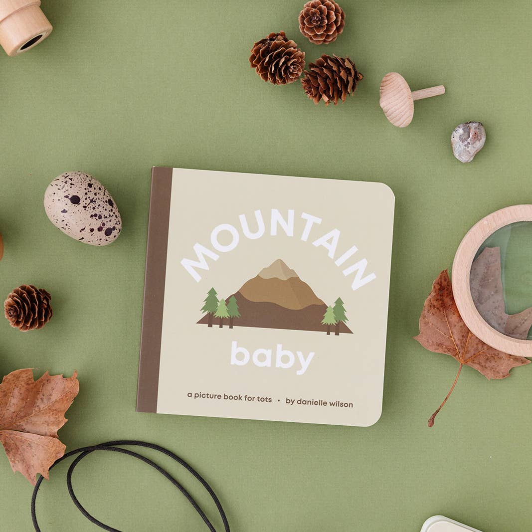 Children's book titled 'Mountain Baby' on a green background with natural elements.