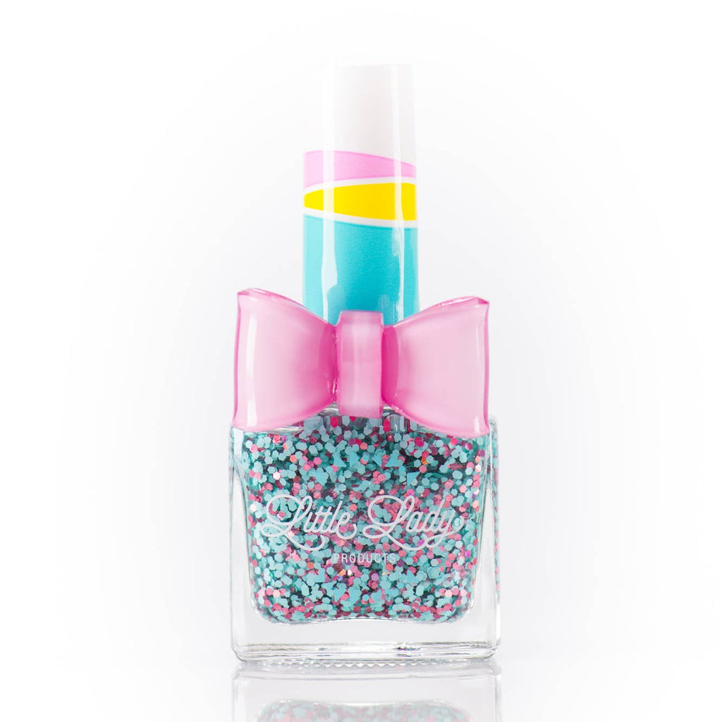 Nail polish bottle with a colorful design and bow on a white background