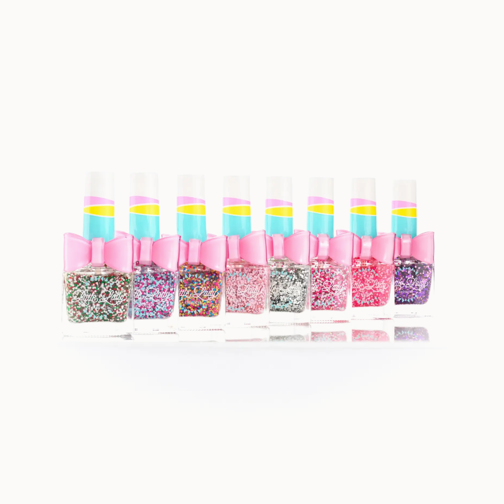 Set of nail polish bottles with colorful designs and pink caps on a white background