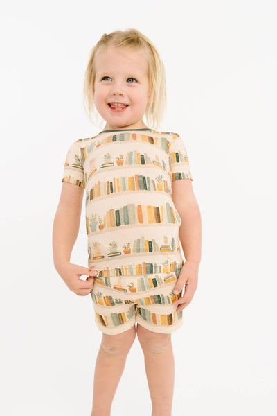 Child wearing a patterned outfit on a white background