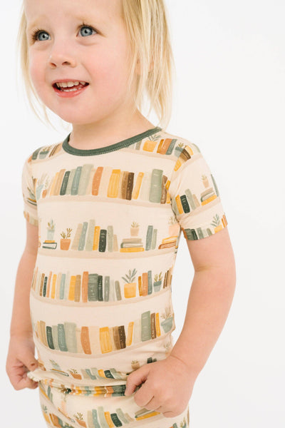 Child wearing a patterned shirt with a white background