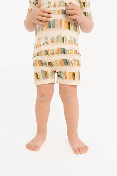 Child wearing a patterned outfit on a white background