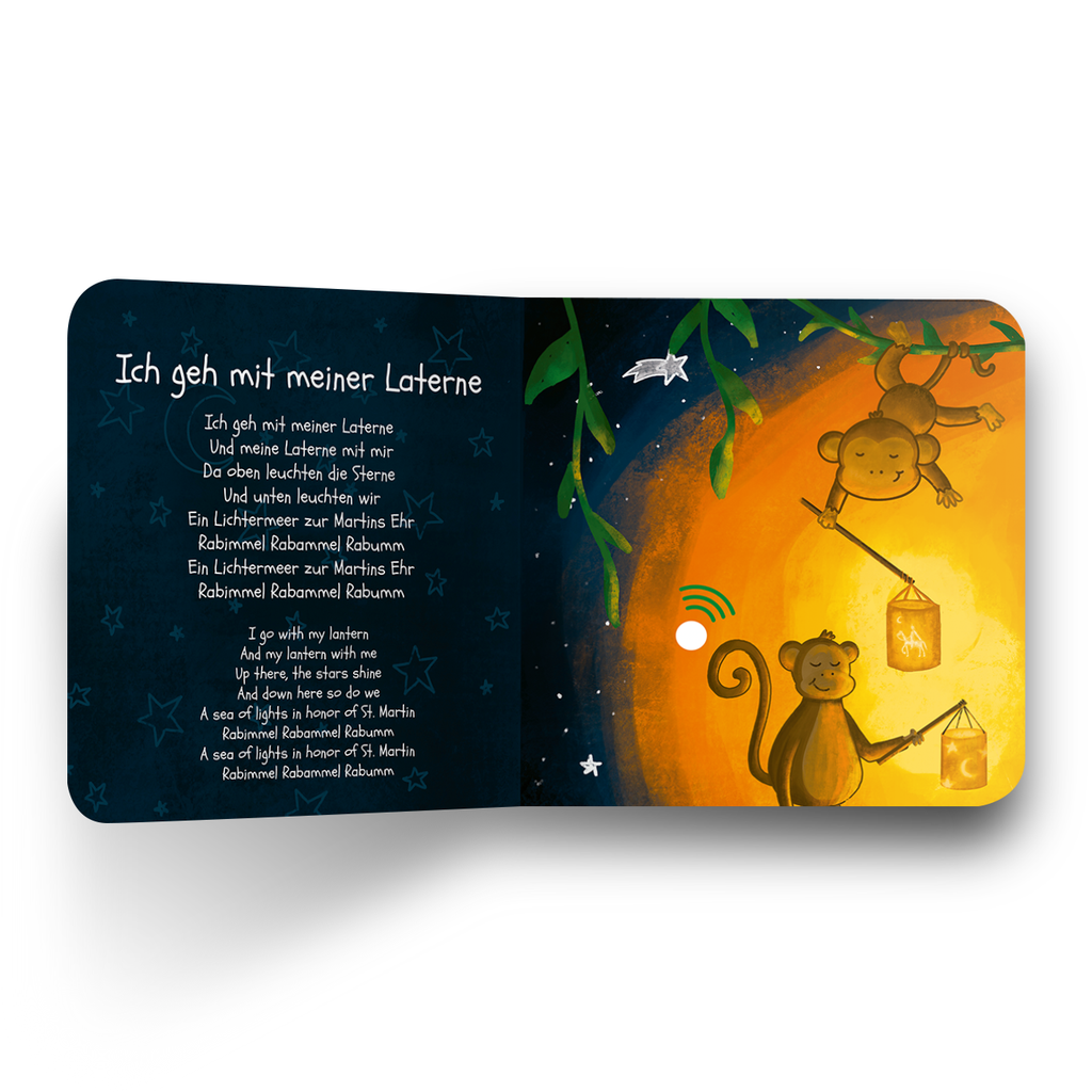 Children's book page with two monkeys holding lanterns against a night sky.