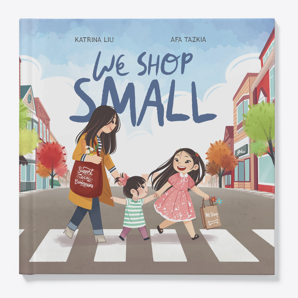 Children's book cover titled "We Shop Small" by Katrina Liu and Afa Tazkia, showing an illustrated mother and child crossing a crosswalk while a daughter joins them, with storefronts and trees in the background.