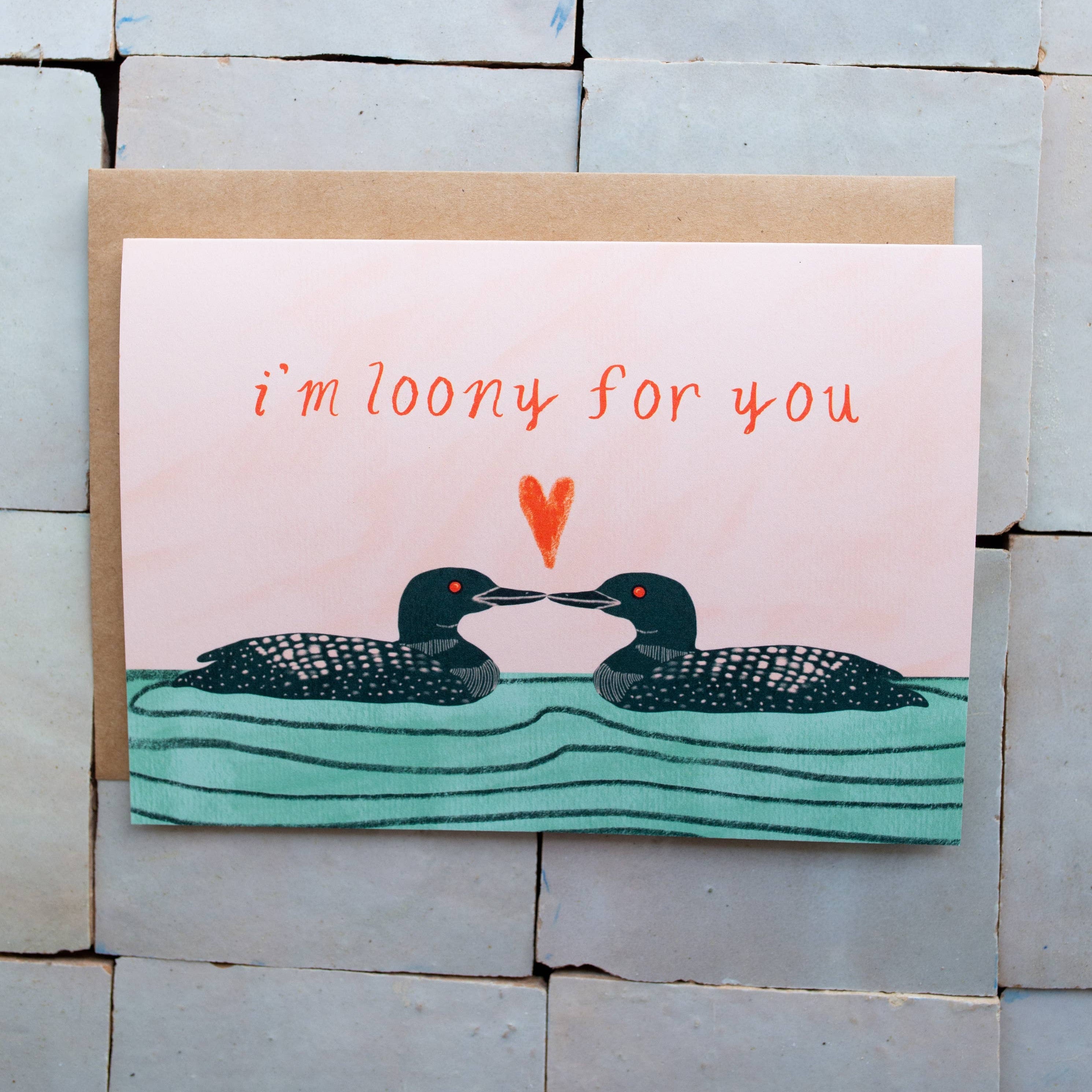 Card with two birds and 'i'm loony for you' text on a tiled wall background