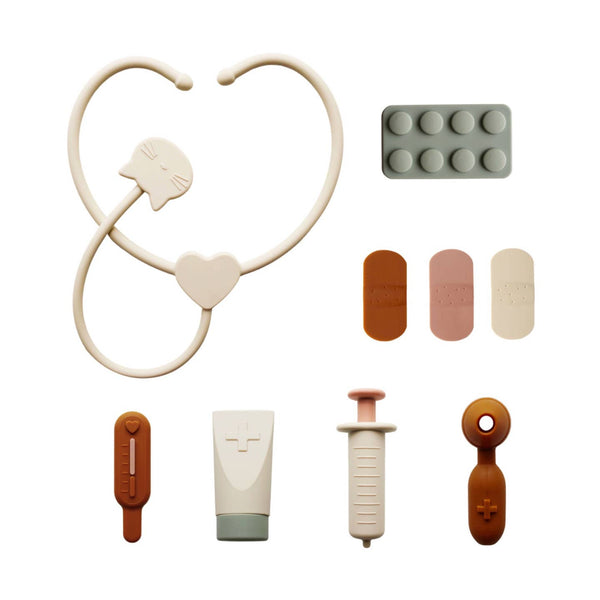 Collection of medical-themed toys including a stethoscope, syringe, and various other items on a white background.