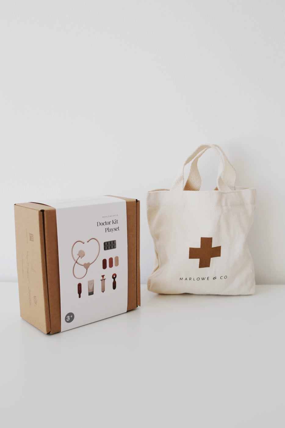 Doctor kit box and tote bag with a cross logo on a white background
