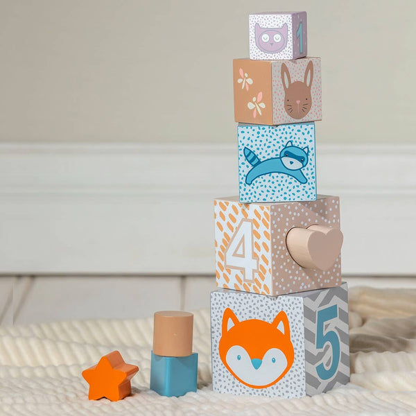 Stack of colorful children's blocks with animal and number designs on a neutral background.