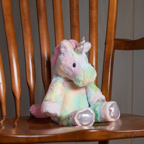 Pastel-colored unicorn plush toy on a wooden chair