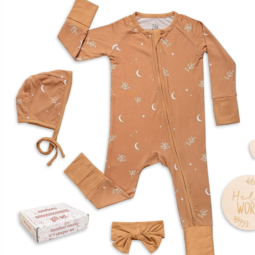 Baby outfit set with onesie, hat, and headband on a white background
