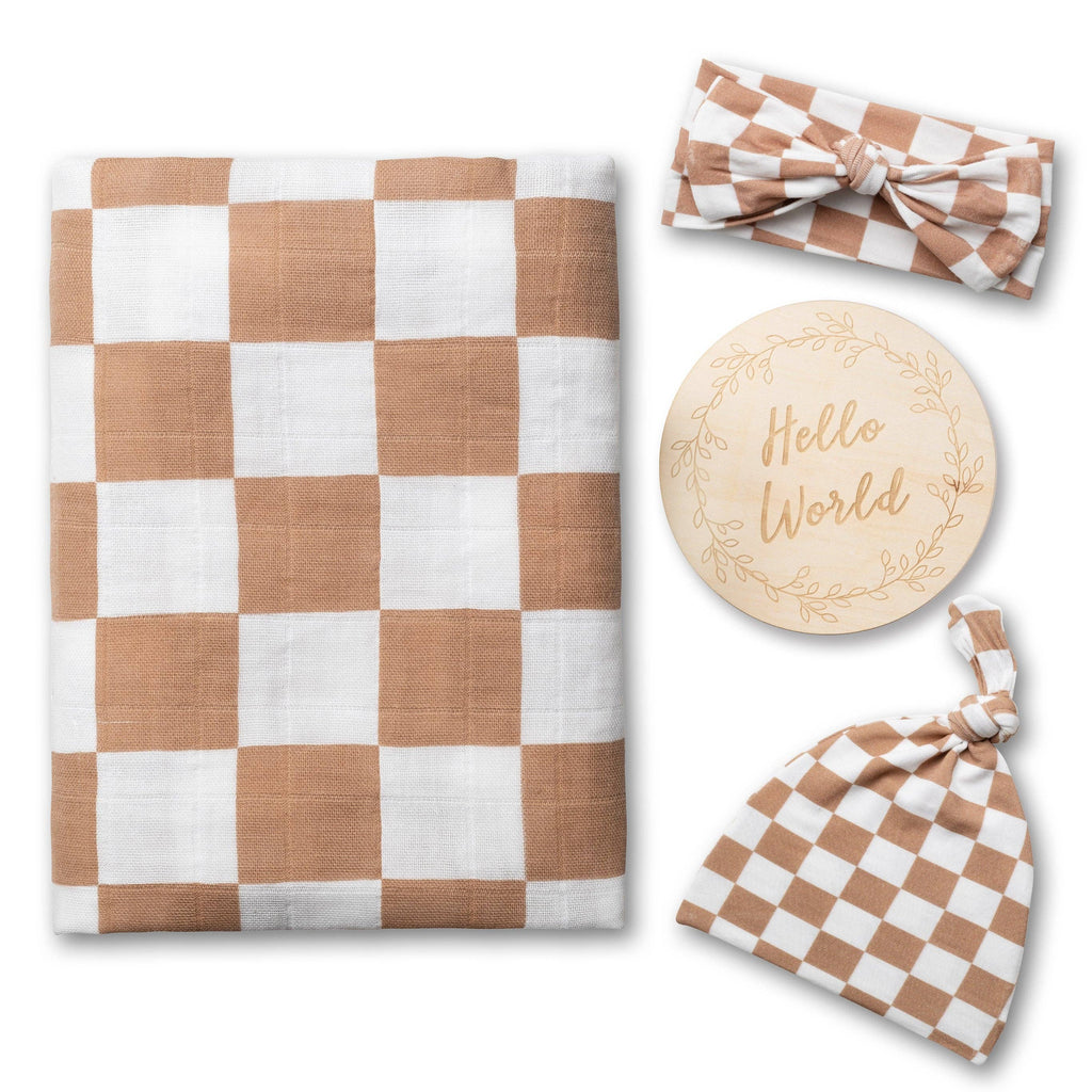 Checkered baby blanket, headband, and hat with 'Hello World' wooden disc on a white background