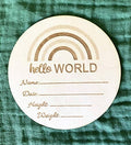 Round wooden card with 'hello WORLD' text and blank lines for personalization on a green textured background.
