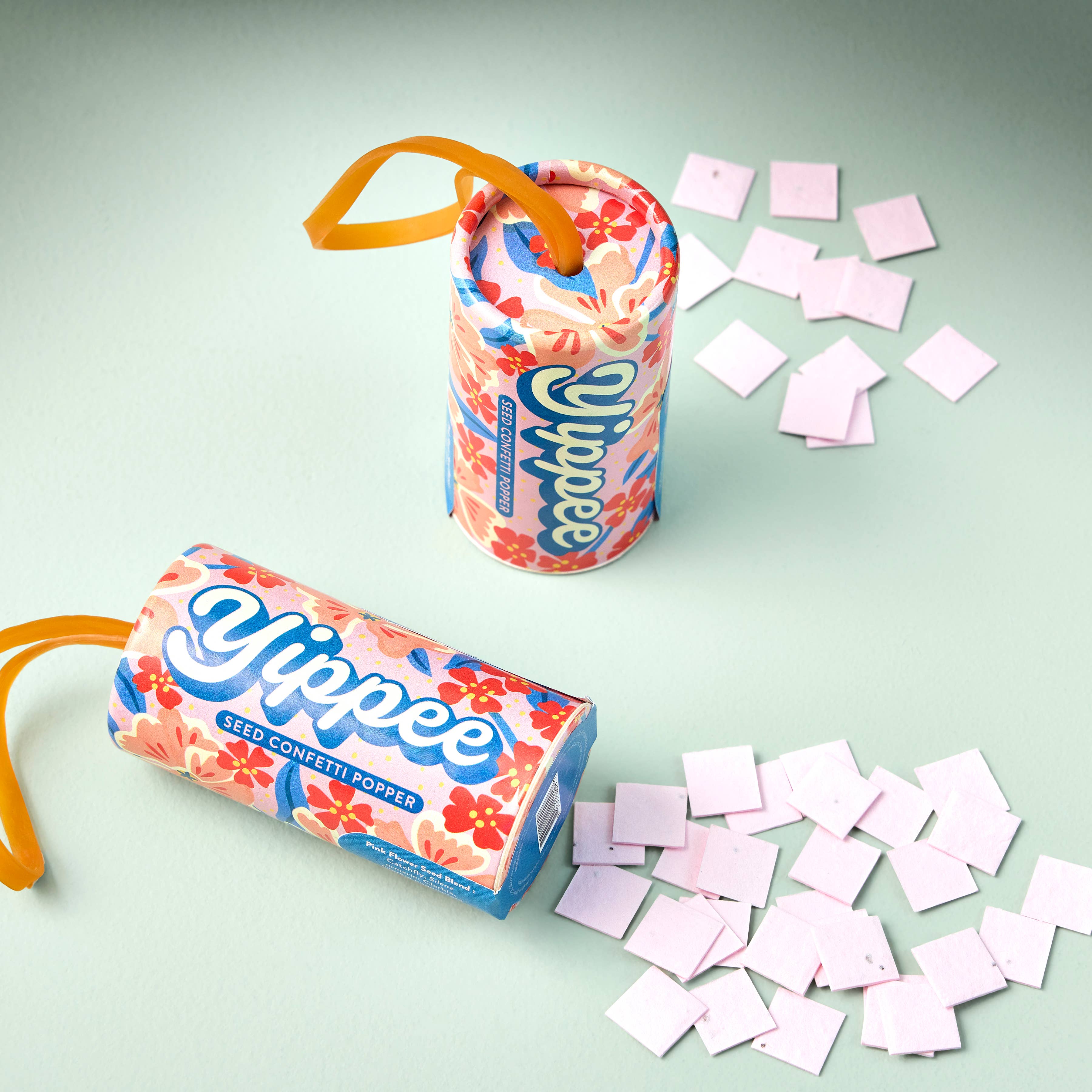 Yippee confetti popper with colorful packaging and scattered confetti on a light green background