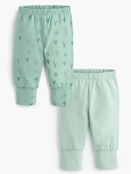 Set of light green pants with cactus pattern on a white background