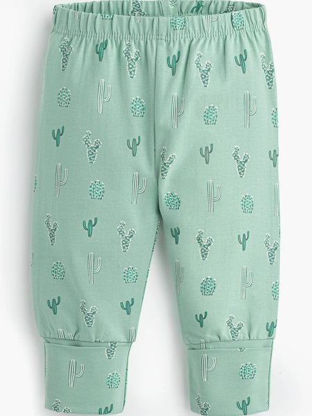 Green pants with cactus pattern on a plain background