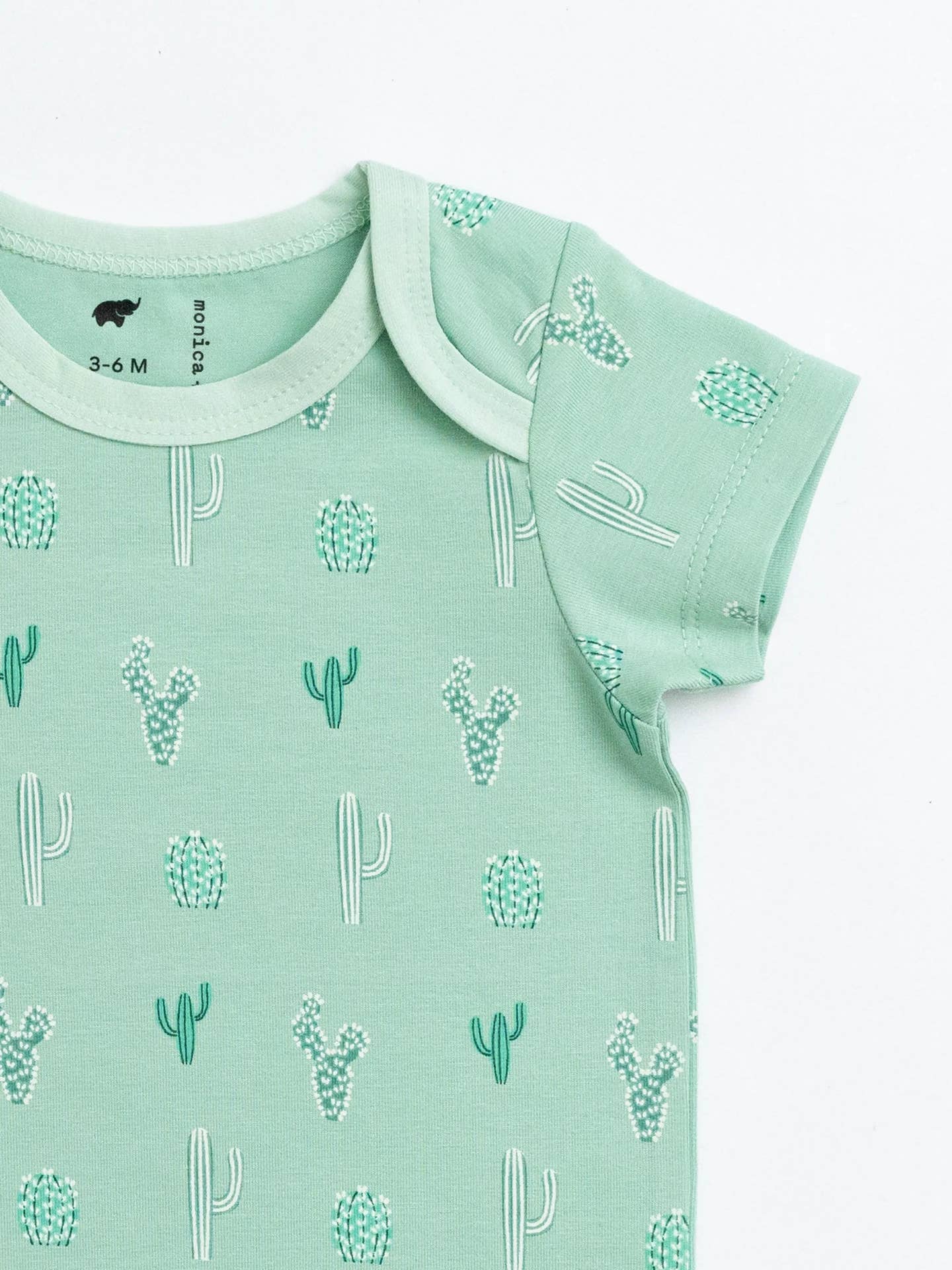 Mint green baby onesie with cactus pattern on a white background