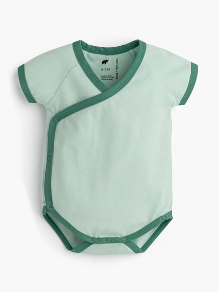 Green baby bodysuit with green trim on a white background