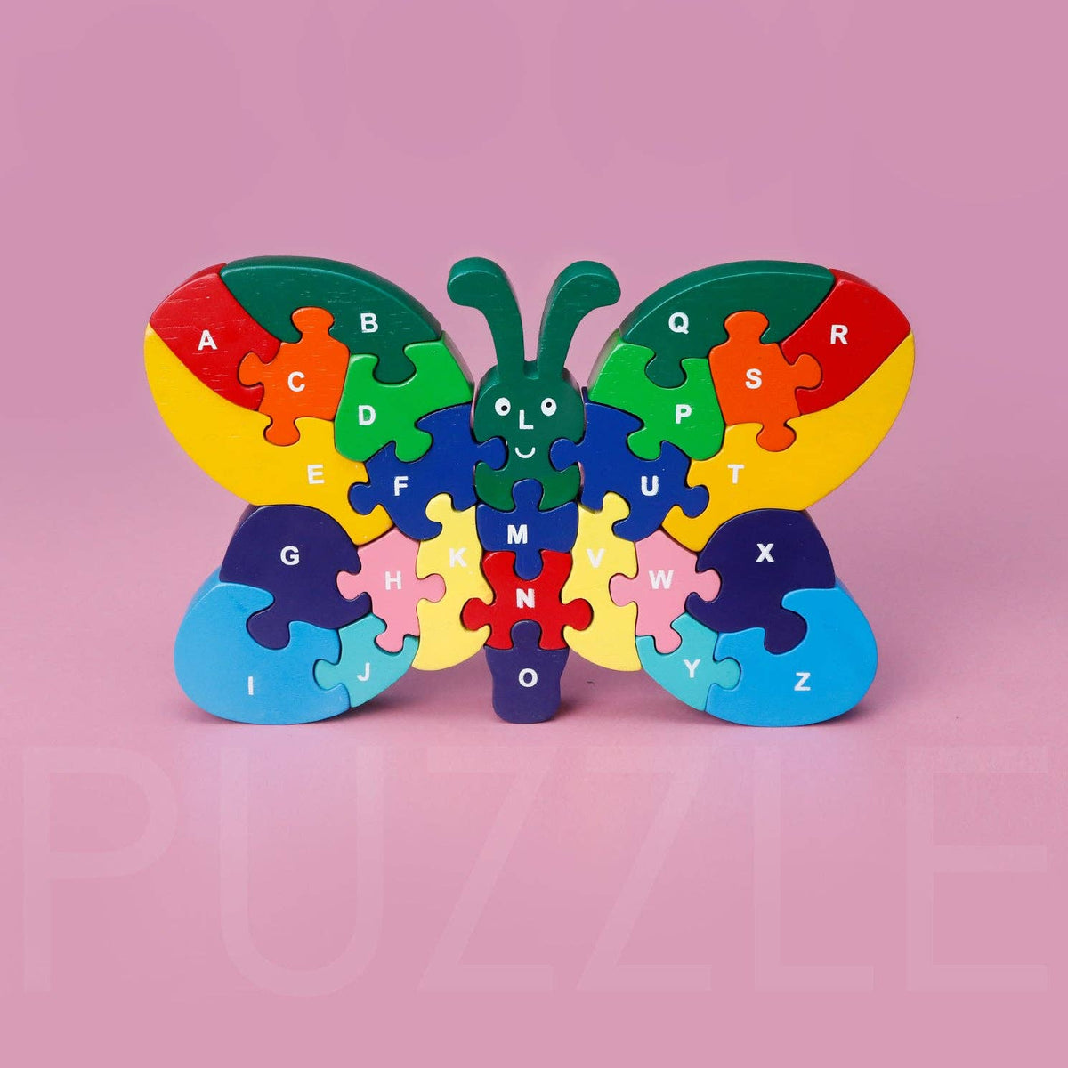 Rainbow colored wooden butterfly puzzle on a pink background