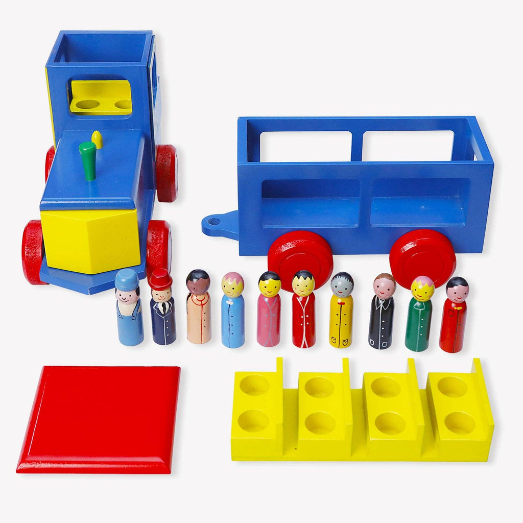 A colorful wooden toy train set on a light gray background, including a blue and yellow train engine with red wheels, a blue cargo car, a red platform, yellow block pieces, and a row of small painted wooden figures.