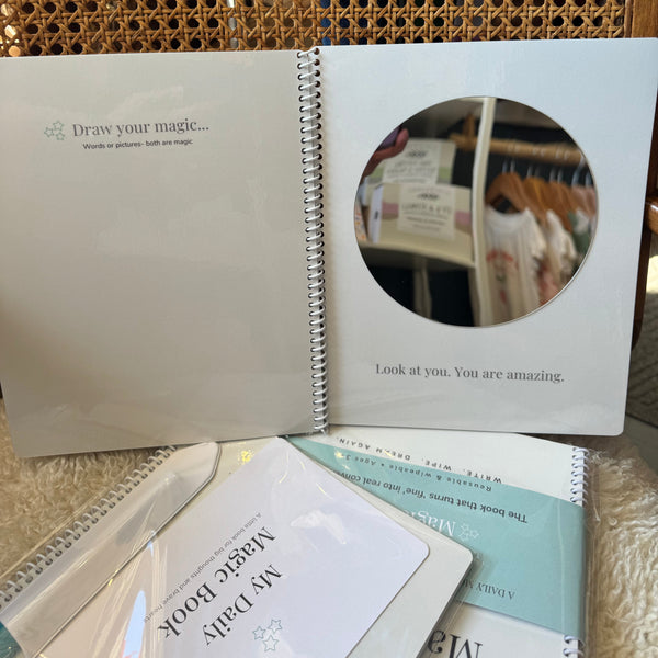 Open book with a circular mirror on a textured surface