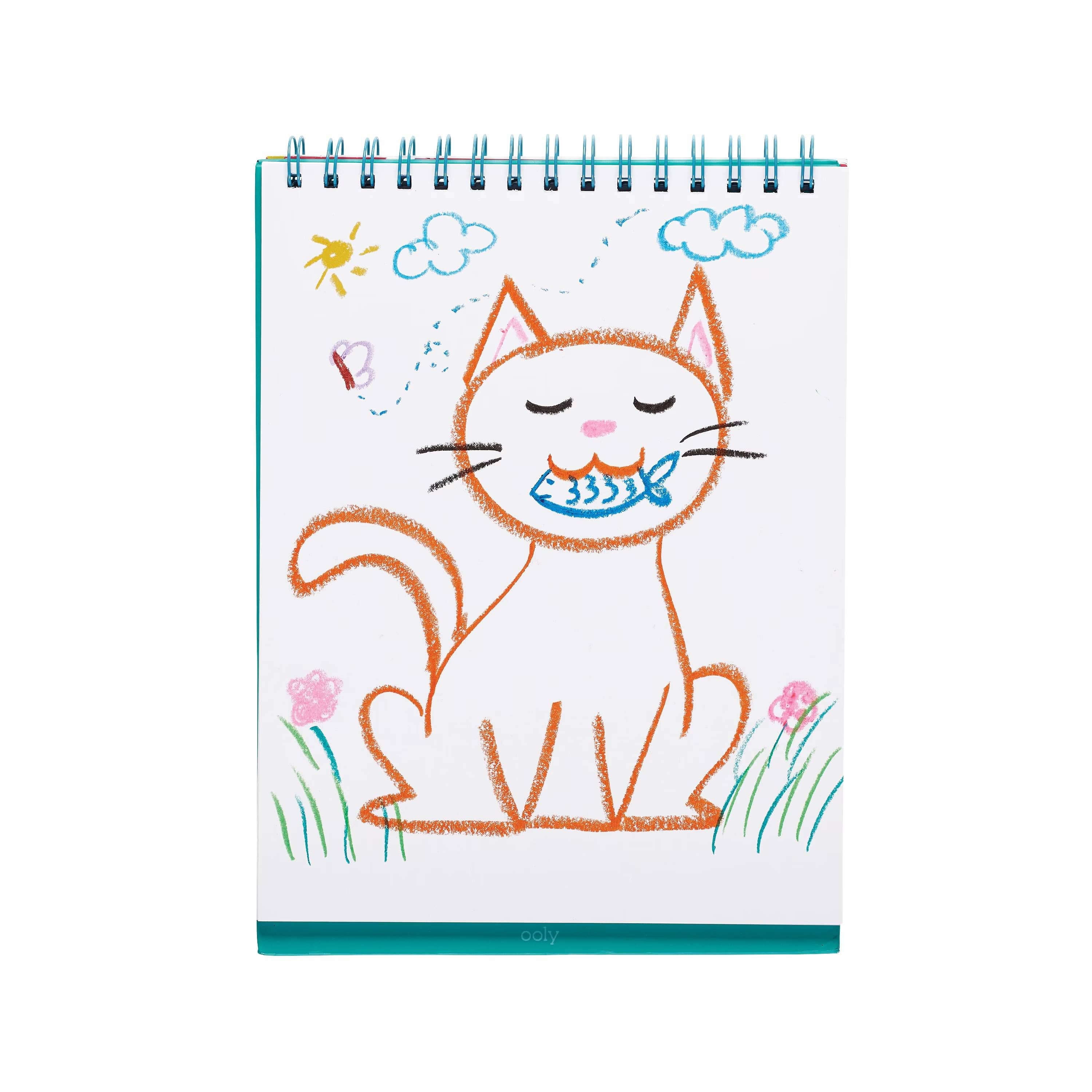 A spiral-bound children's notebook featuring a hand-drawn orange cat holding a blue fish on a white page, with simple colored illustrations of clouds, flowers, grass, and a sun.