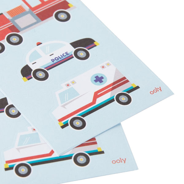 Two sheets of paper with colorful vehicle illustrations on a light blue background, featuring police car and ambulance designs.