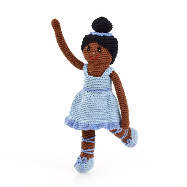 Crocheted doll with brown hair and a blue dress on a white background