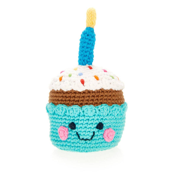 Crocheted cupcake toy with a smiling face on a white background