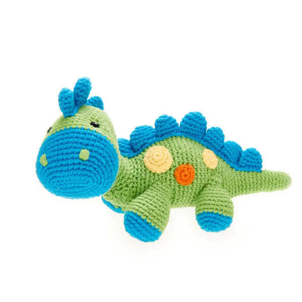 Crocheted dinosaur toy with blue spikes and colorful accents on a white background