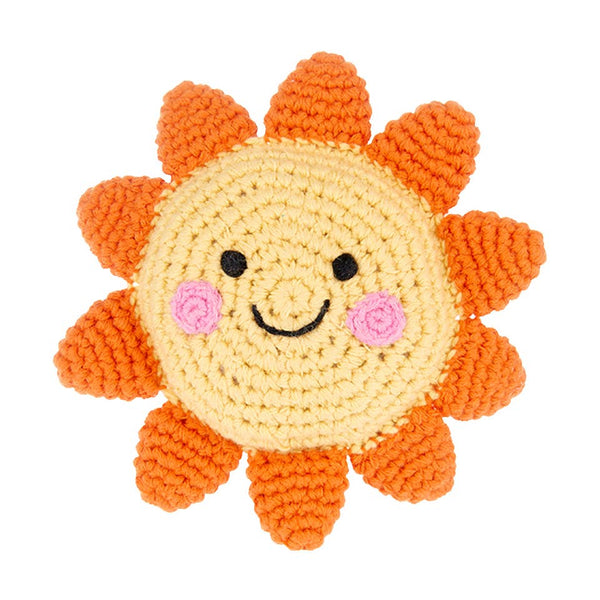 Crocheted sun-shaped toy with a smiling face on a white background