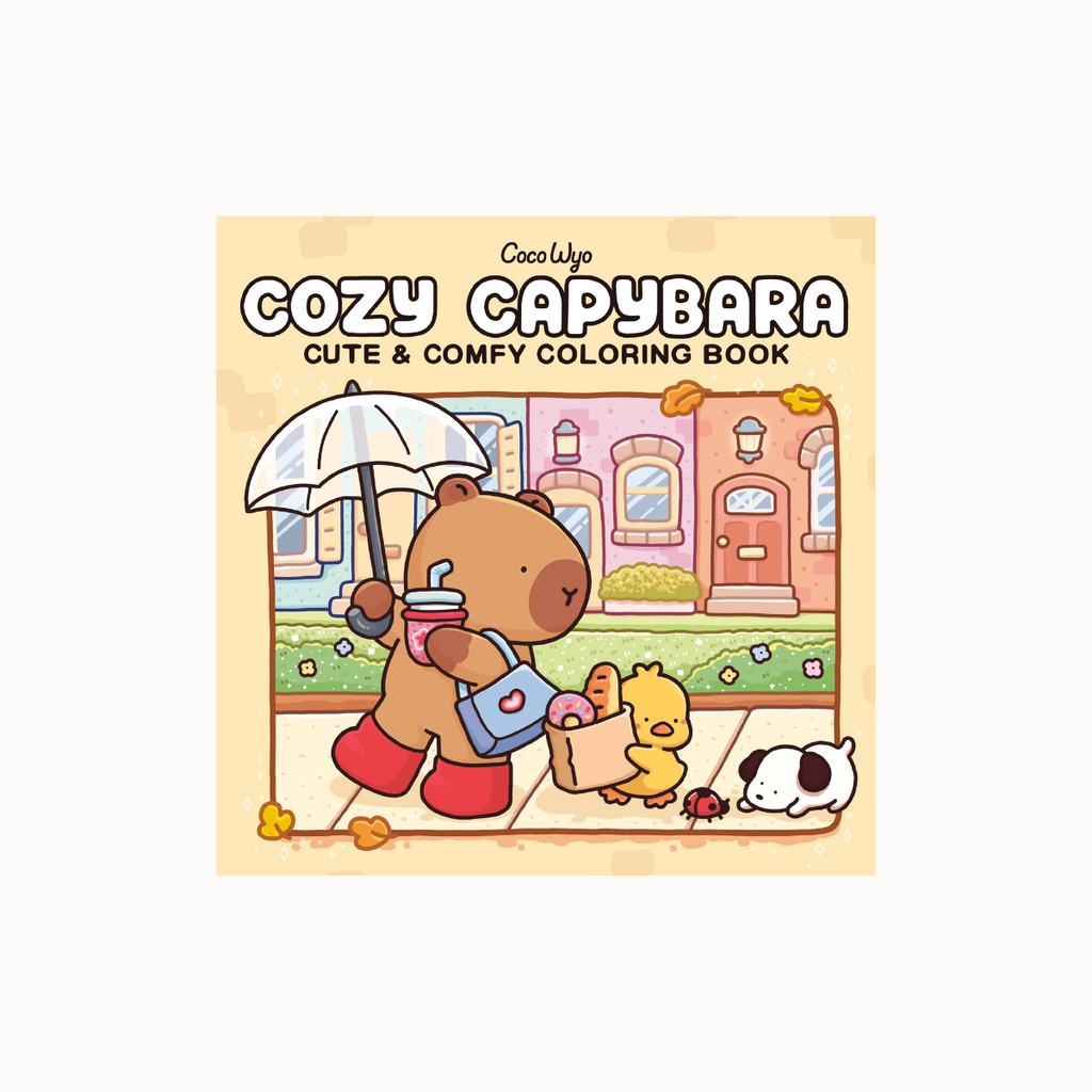 Front cover of the 'Cozy Capybara Cute & Comfy Coloring Book' by CozyWife, featuring a cute cartoon illustration of a brown capybara holding an umbrella and shopping bag on a sidewalk.