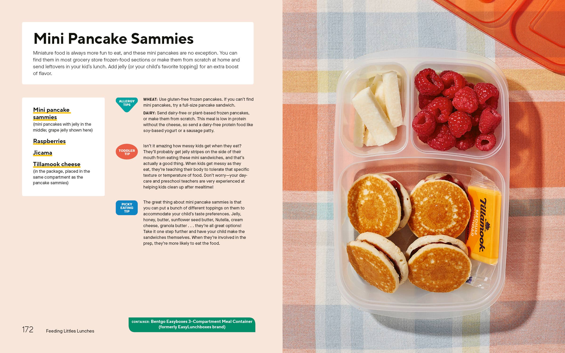 Mini pancake sammies in a lunch container with raspberries and cheese on a checkered tablecloth.