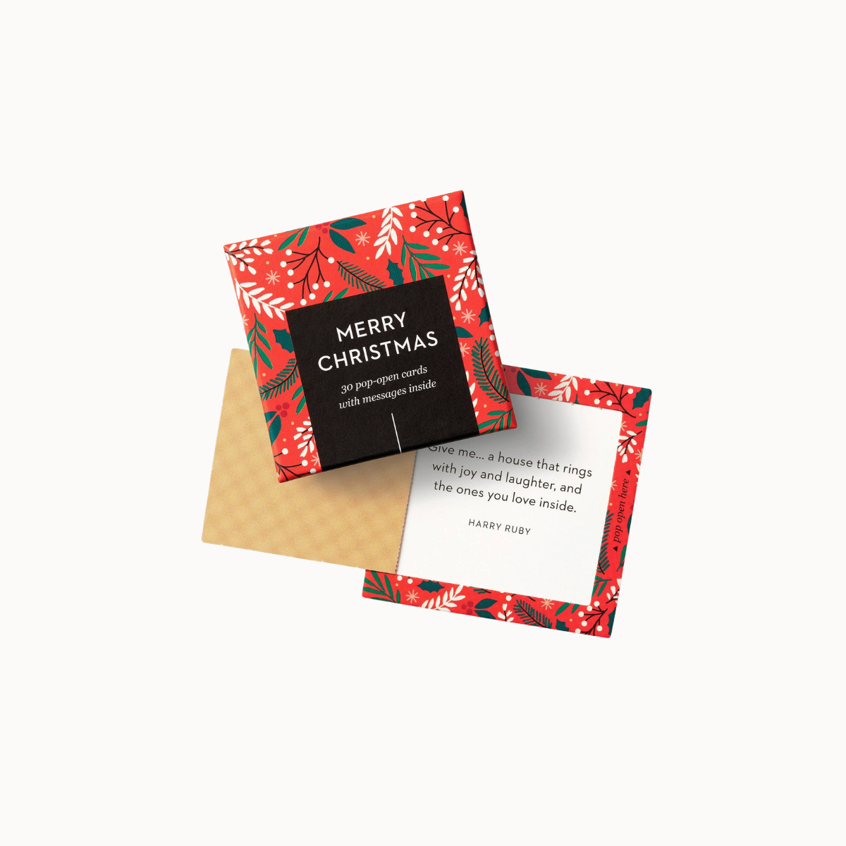 A Christmas-themed greeting card set shown on a clean white background. The set includes a red patterned outer sleeve with green and white holiday motifs, a black square label reading 'MERRY CHRISTMAS' with white text, a beige envelope, and an open white card with a poem printed inside.