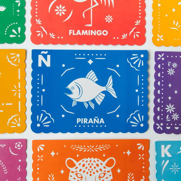 Colorful papel picado with various designs and text on a white background