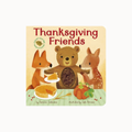 A children's board book titled 'Thanksgiving Friends' with illustrated woodland animals sharing food on a table. The cover shows a fox, a bear, and a deer with pies, pumpkin, and bread, on a cream background with rounded corners.