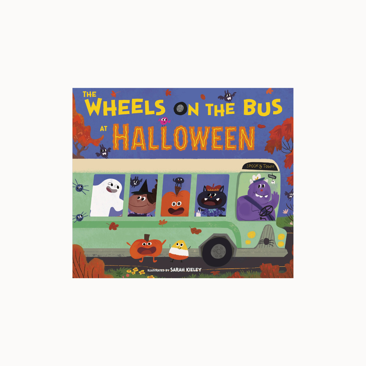 The Wheels on the Bus at Halloween children's book cover, featuring a green bus with spooky characters like ghosts, a pumpkin, and a black cat in a Halloween-themed illustration.