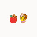 A pair of gold-tone enamel stud earrings shaped like a red apple with a green leaf and a yellow pencil with a pink tip, shown on a plain off-white background.