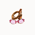A gold-toned metal key ring accessory with two dangling pink and lavender enamel axolotl charms, shown on a plain white background.